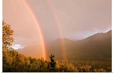 Sunset view of a double rainbow arching over Eagle River Valley after a passing storm, Southcentral Alaska, Summer