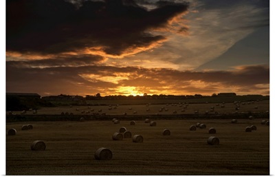 Sunset With Dark Clouds Over A Field With Hay Bales, Whitburn, Tyne And Wear, England