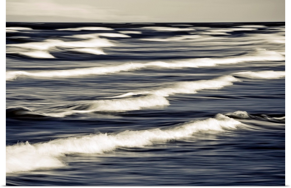 Big photo on canvas of waves breaking up close in the ocean.