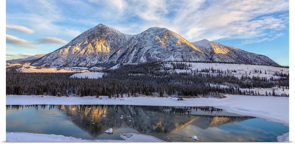 Late winter afternoon light warms up the mountains along the Takhini River, near Whitehorse. Yukon, Canada.