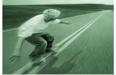 Teenager Skateboarding Down Road
