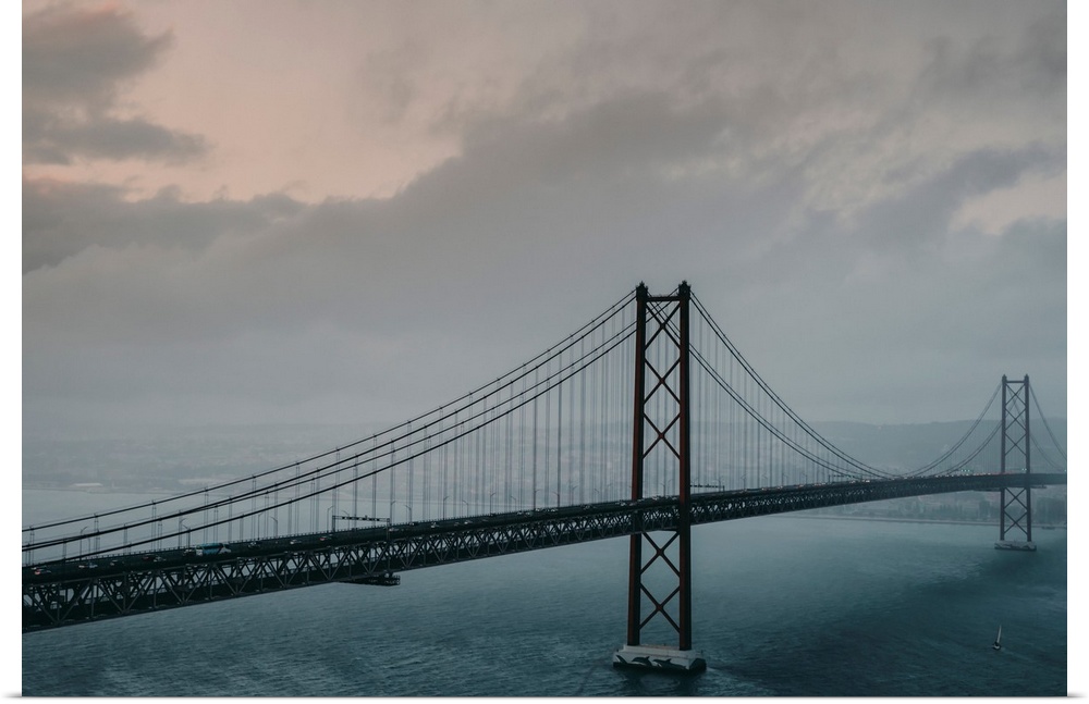 The 25 de Abril Bridge crossing the Tagus River, connecting Lisbon and Almada on a grey, foggy day, Lisbon, Estremadura, P...
