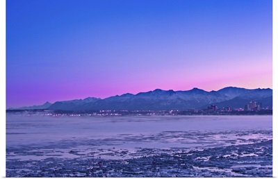 The Anchorage Skyline before dawn with fog rising from the waters of Knik Arm