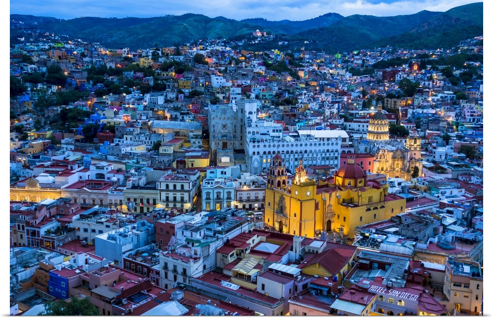 Overview of city at dusk with the Guanajuato Basilica painted in yellow in Guanajuato City, Guanajuato, Mexico