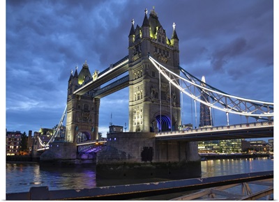 Tower Bridge Illuminated At Dusk And Reflected In The River Thames, London, England