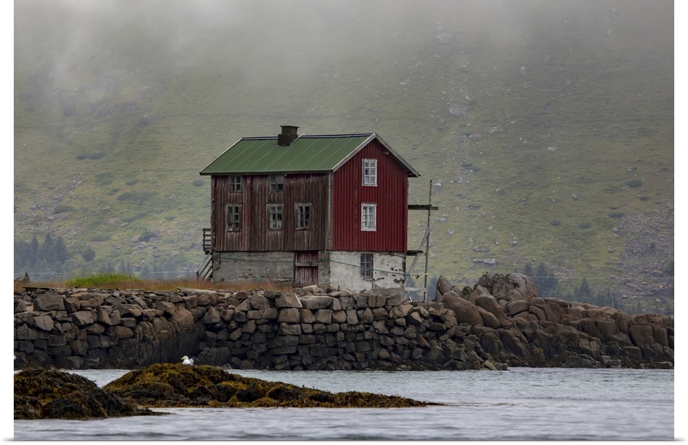 Traditional fishing village house next to the shoreline in Lofoten, Lofoten, Arctic Circle, Norway
