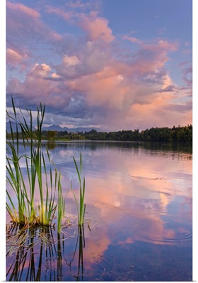 View of sunset clouds reflected in  Westchester Lagoon near downtown Anchorage