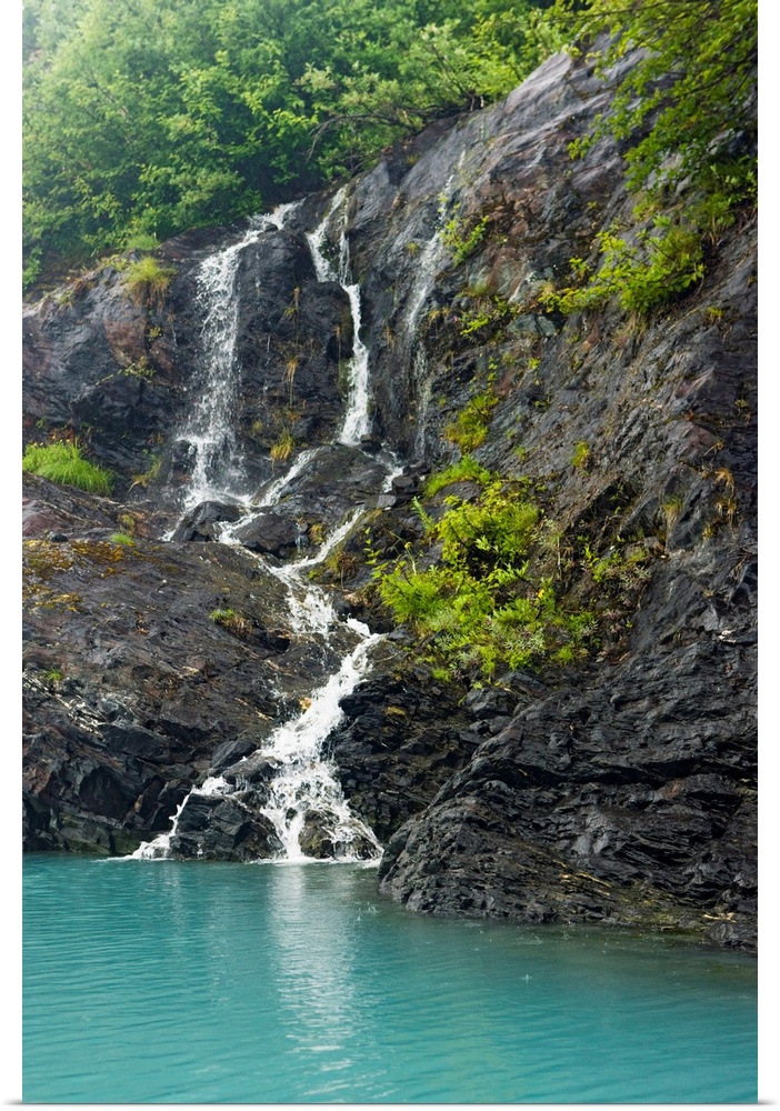 Waterfall cascading down the rocks of the Passage Canal in Whittier, Alaska.