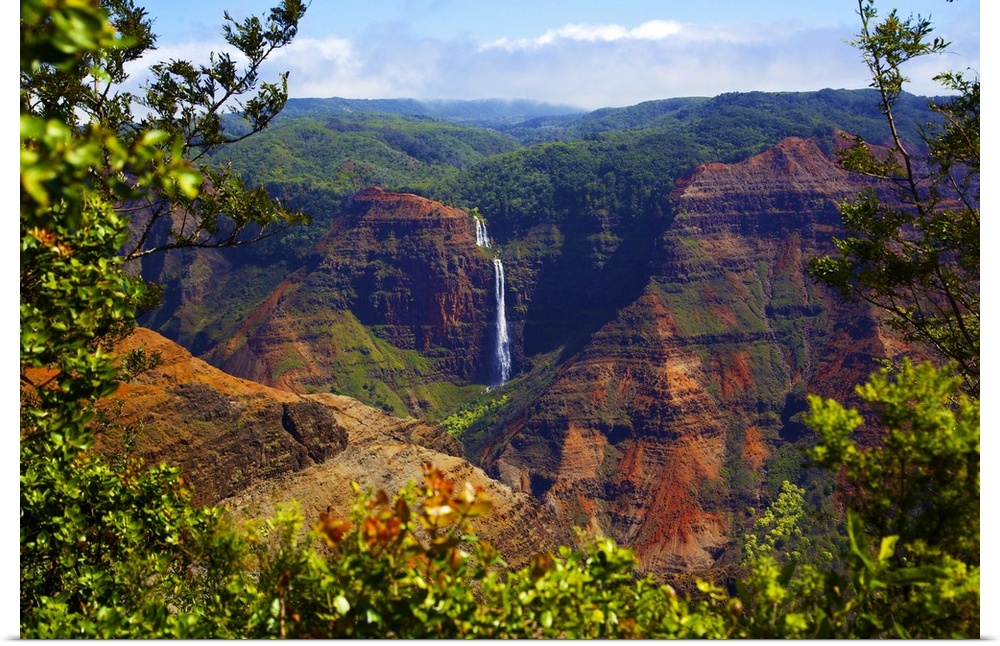 Waimea Canyon Falls and lush foliage on rugged cliffs and mountains; Waimea, Kauai, Hawaii, United States of America