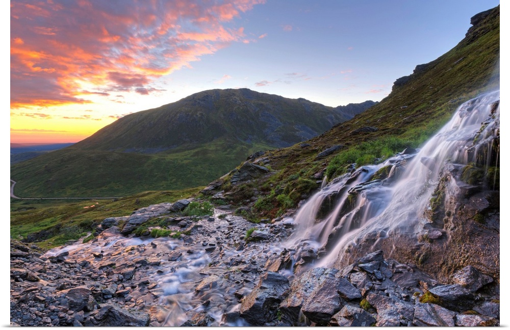 Scenic sunset view of a waterfall at Summit Lake State Recreation Site, Hatcher Pass, Alaska.