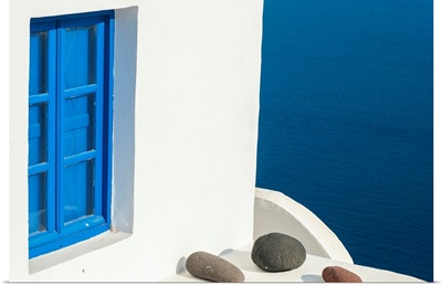 Whitewash building with blue trimmed window along the Aegean sea, Oia, Santorini, Greece