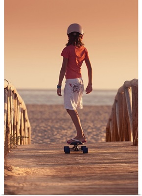 Young Person Skateboarding On A Wooden Boardwalk Towards Beach, Andalusia, Spain