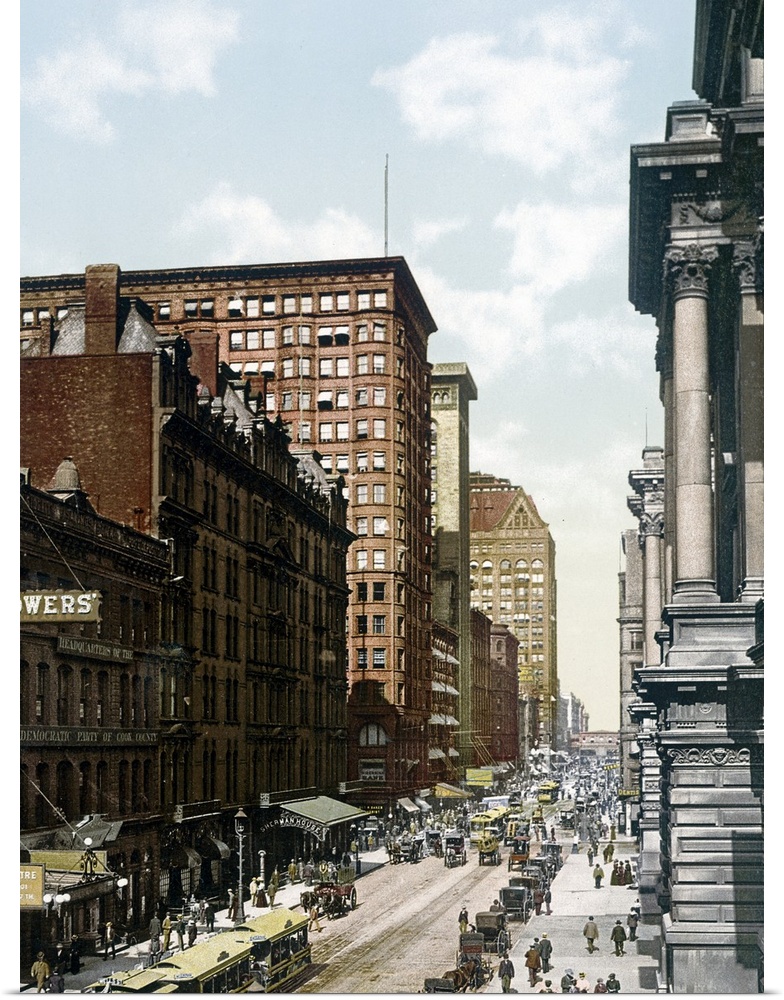 Vintage photo on canvas of a street in Chicago with people and antique cars going up and down the street.