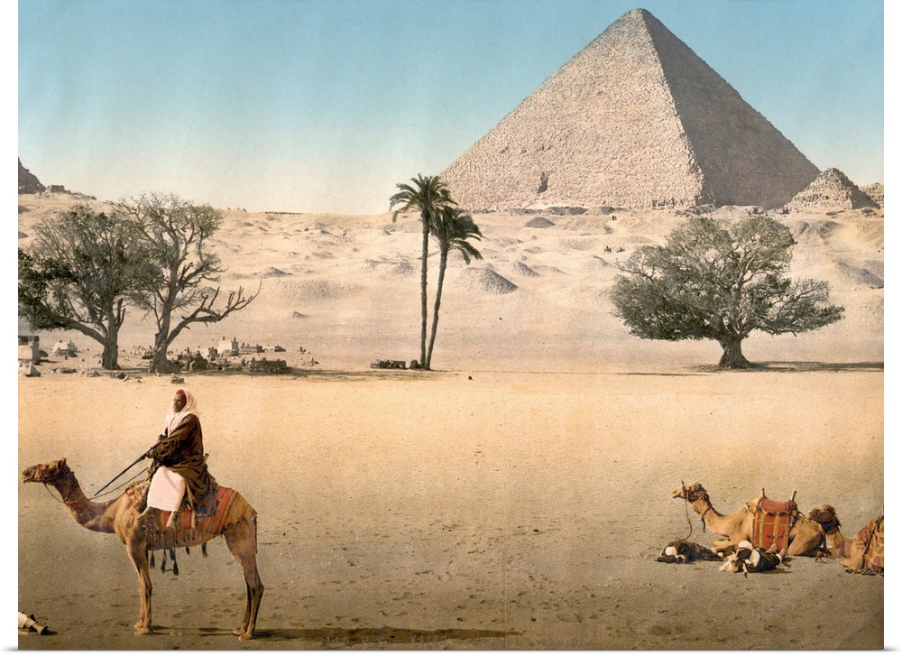Hand colored photograph of resting Bedouins and the grand pyramid, Cairo, Egypt.