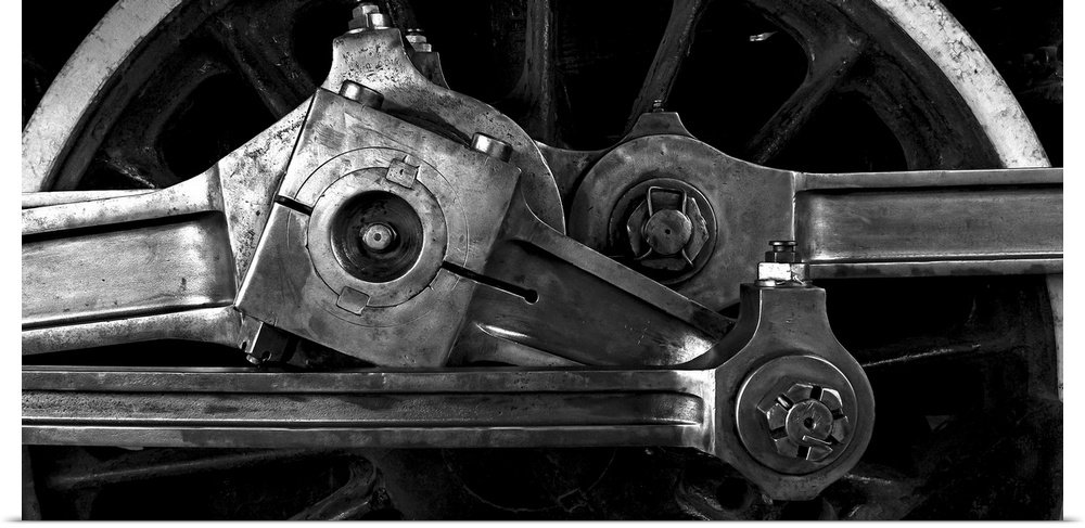 Black and white photograph of the gears on a large train.