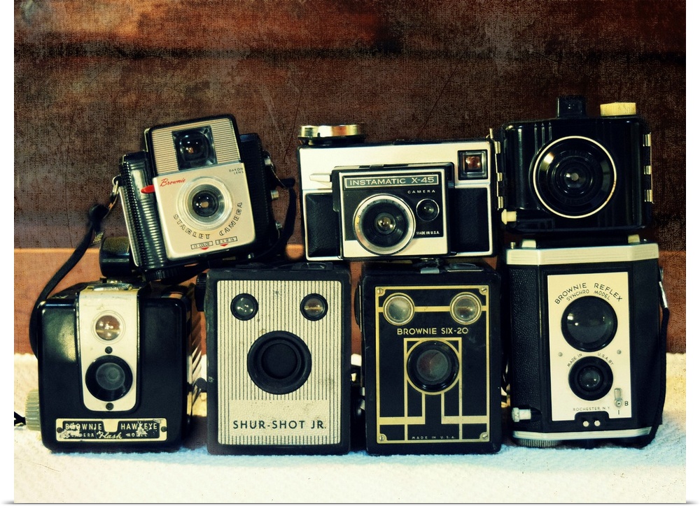 Photograph of stacked vintage cameras.