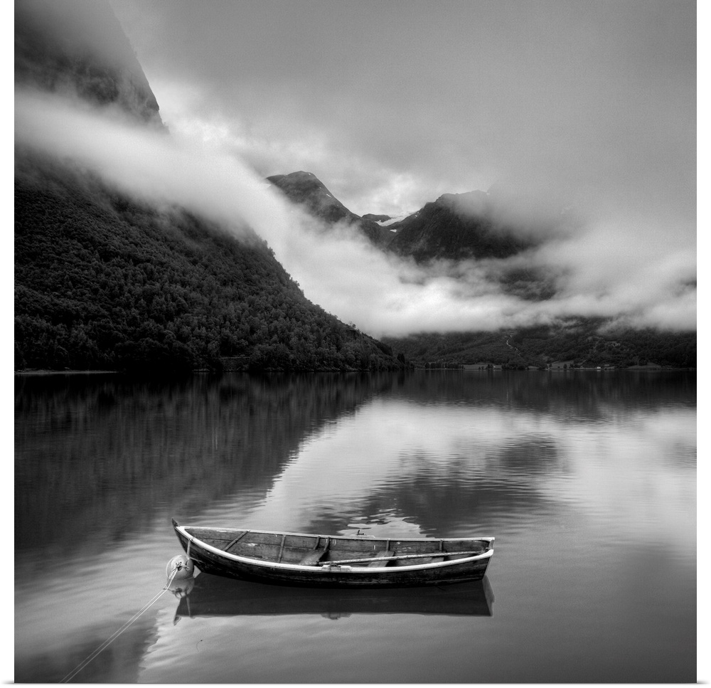 Boat surrounded by foggy mountains