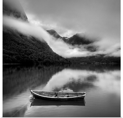 Boat surrounded by foggy mountains