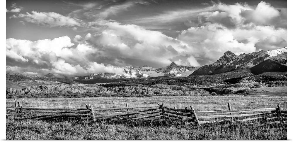 Fence on a farm, mountains in the background, black and white photograph