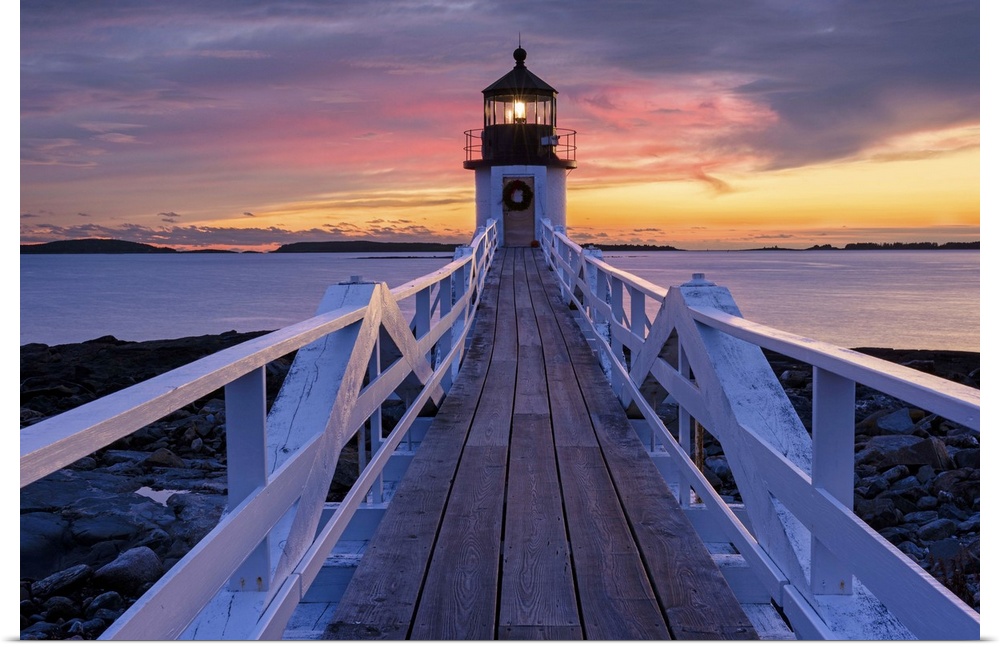 A photograph of a lighthouse under a sunset sky.
