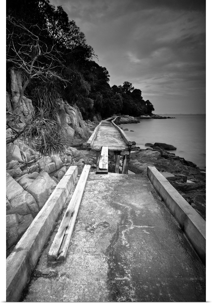 broken walkway over water black and white photograph