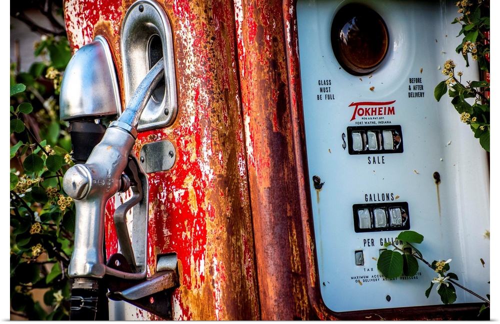 Photograph of an old, rusted, antique gas pump.