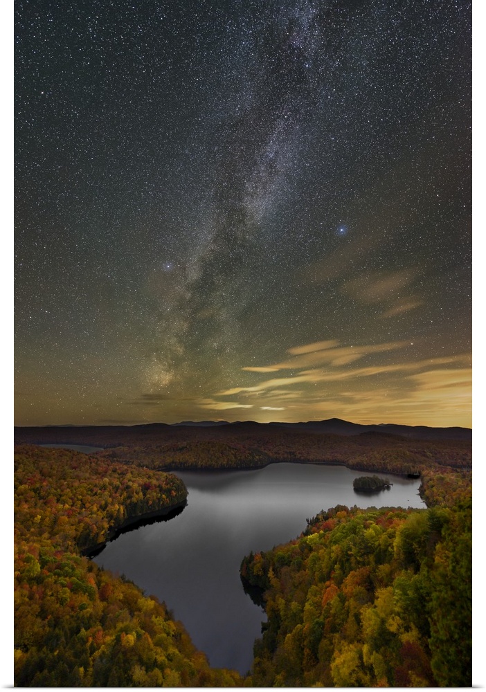 A photograph of a serene wilderness landscape under a night sky.