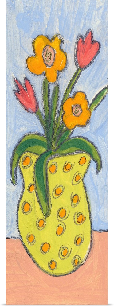 A yellow polka-dotted vase of flowers.