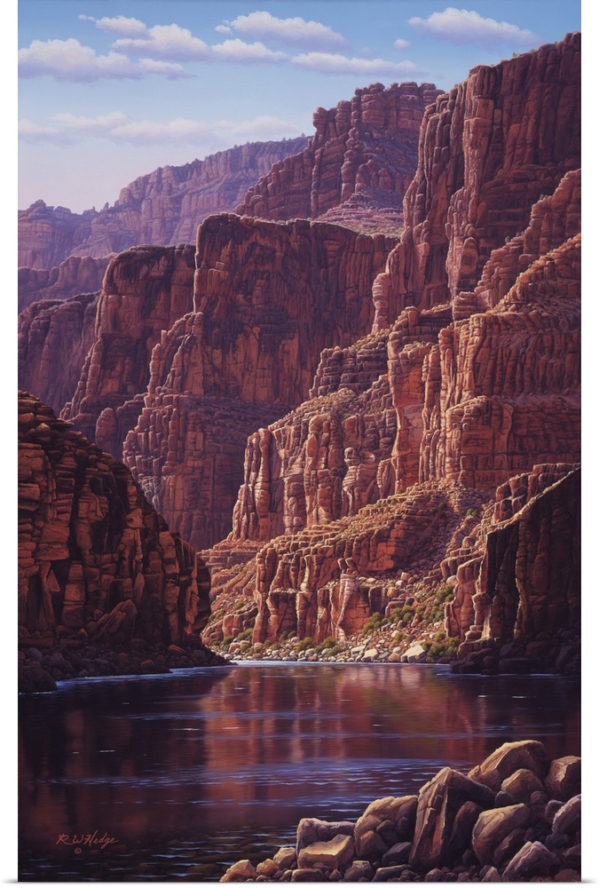 A calm river flows through the bottom of a canyon.