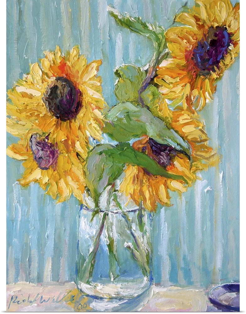 Sunflowers in a clear glass vase.
