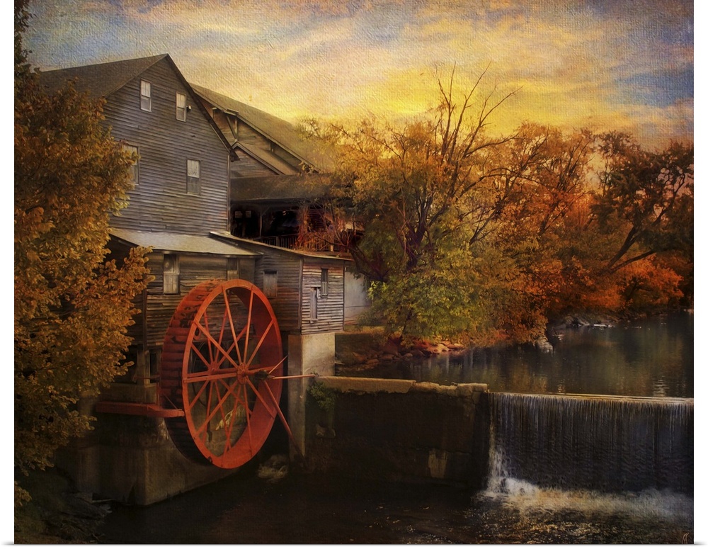 Fine art photo of a water mill at sunset in the fall.