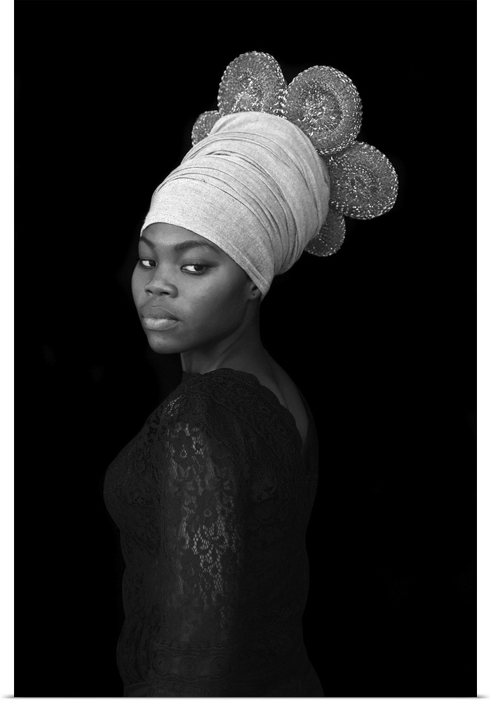 A stunning contemporary black and white portrait of a young Black woman wearing an elaborate wrapped headcovering