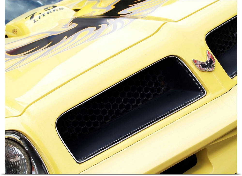 Angled photograph of the front of a yellow 1976 Pontiac Trans Am.