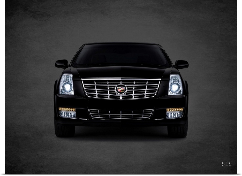 Photograph of a black Cadillac SLS printed on a black background with a dark vignette.