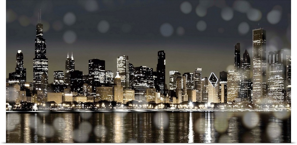 The Chicago skyline lit up at night with from across the water with bokeh lights in the foreground.