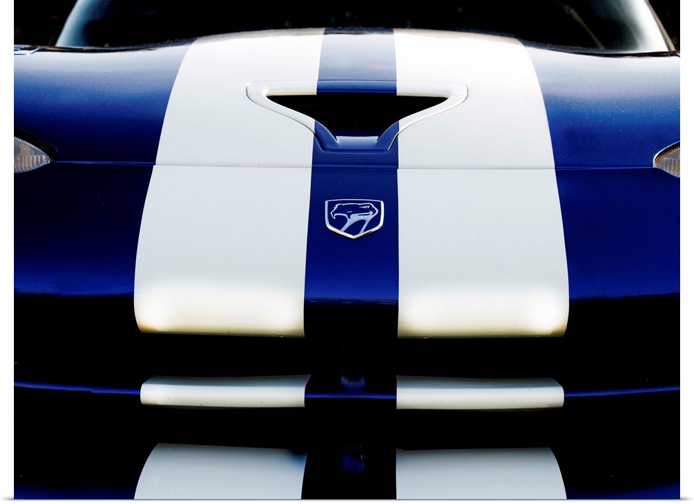 Close-up photograph of the front of a blue Dodge Viper 4 with two white stripes running down it.