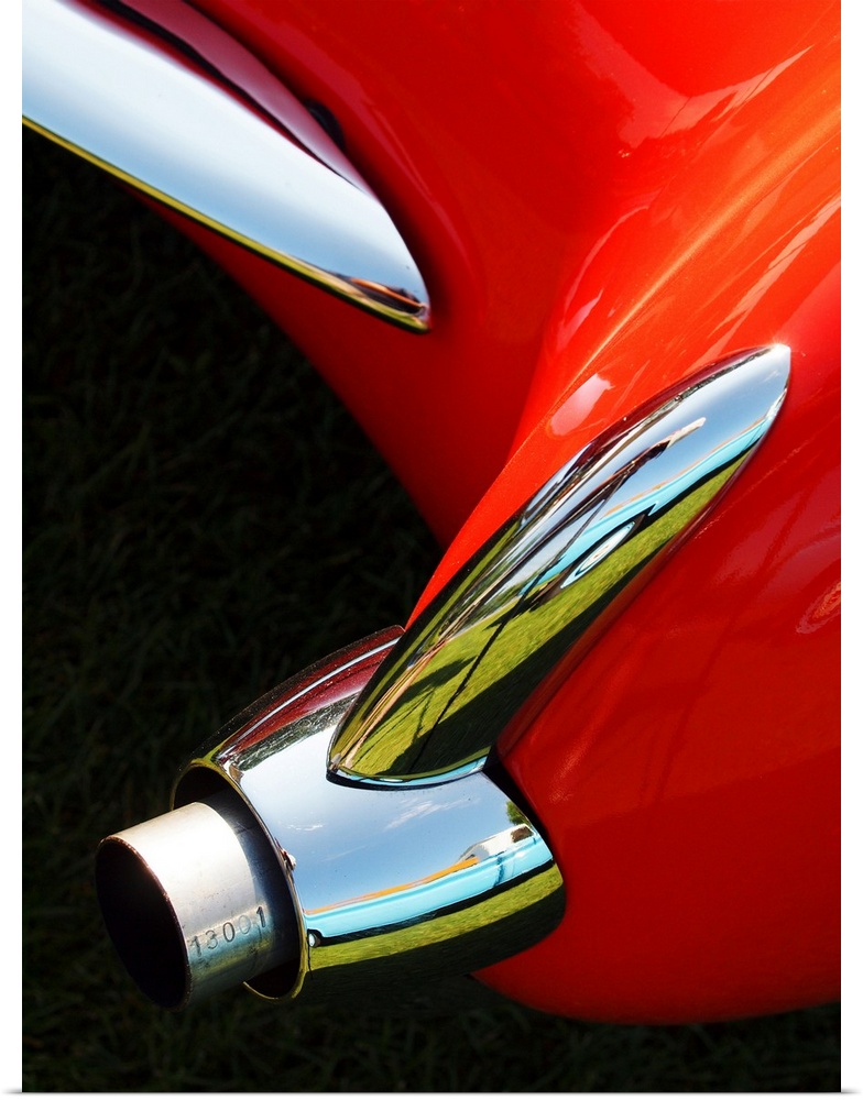 Photograph of the rear exhaust on a red 1956 Corvette.