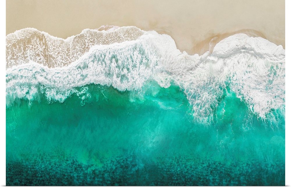 One artwork in a series of aerial shots of a beach as teal waves break upon the shore.