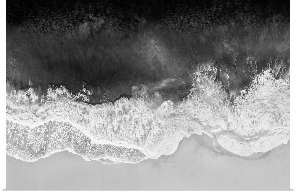 One artwork in a series of aerial shots of a beach as dark gray waves break upon the shore.