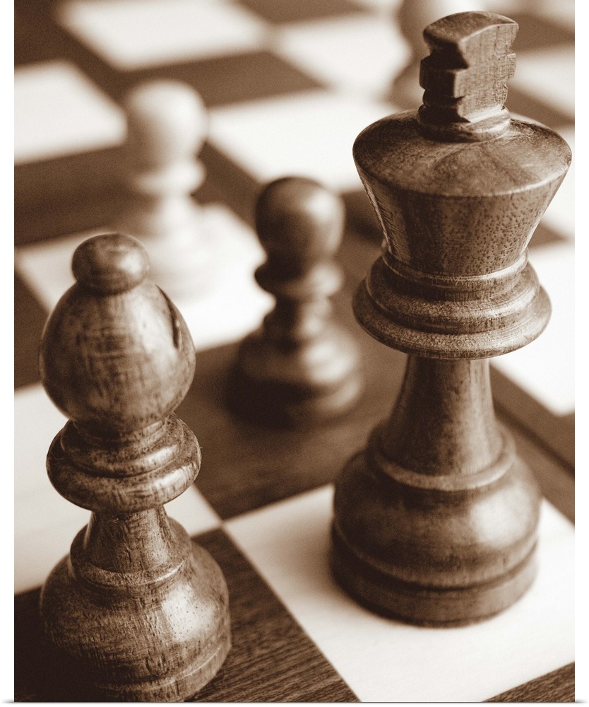 Sepia toned photo of chess pieces on a game board.