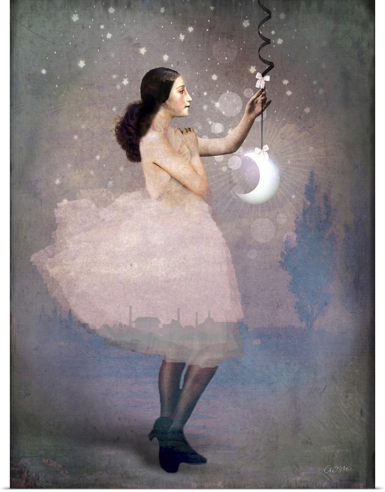 A lady in pink is holding a crescent moon hanging from a ribbon.