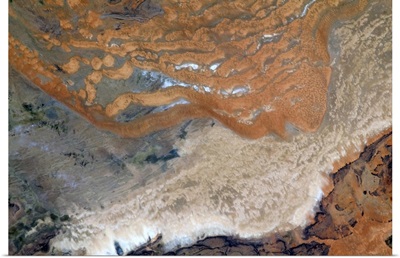 Alien red sand crawls over a bereft African plain