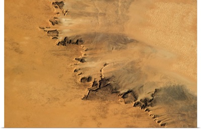 Arid fingers of sand-blasted rock in the hot Saharan wind