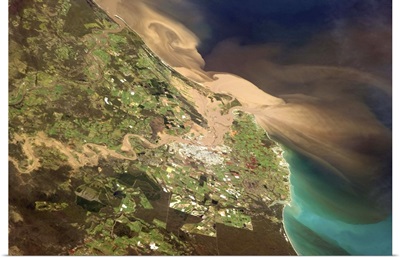 Floodwaters pour through Bundaberg and into the ocean in Australia on Tuesday morning