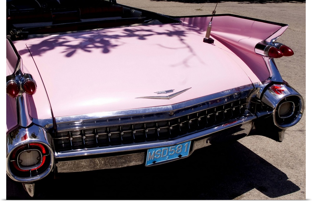 Classic 1959 pink Cadillac convertible on road in beautiful Varadero Beach in Valadero Cuba