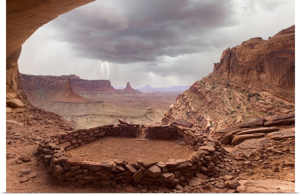 USA, Utah, Canyonlands National Park. View of Anasazi ruin with thundercloud and lightning in background.