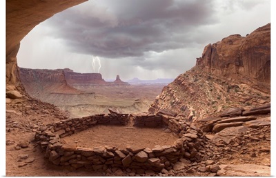 Anasazi ruins with thundercloud and lightning in background