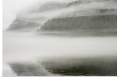 British Columbia, Calvert Island, Mist and fog shroud water and forested island