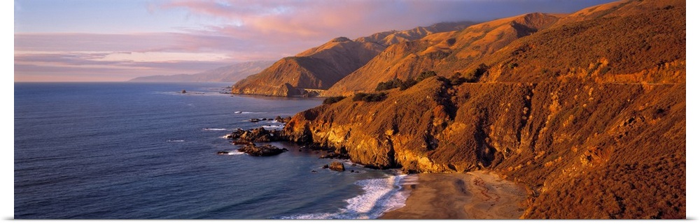 USA, California, Big Sur. Sunset casts a golden hue over the Coast Range near Big Sur, on Highway 1 in central California.