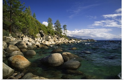 California, Lake Tahoe, smooth granite boulders line the lake shore in clear water